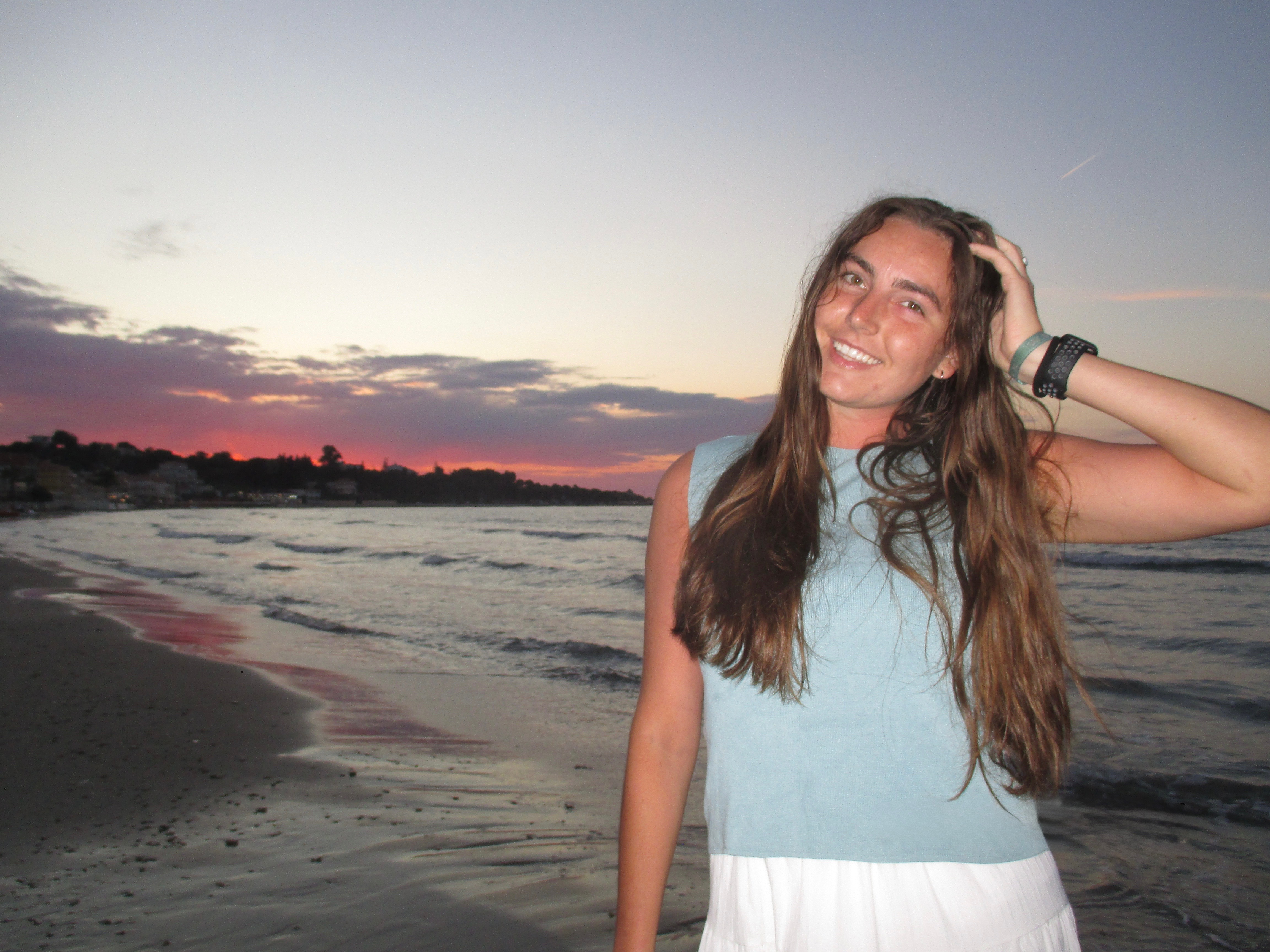 Paetan smiling on a beach at sunset